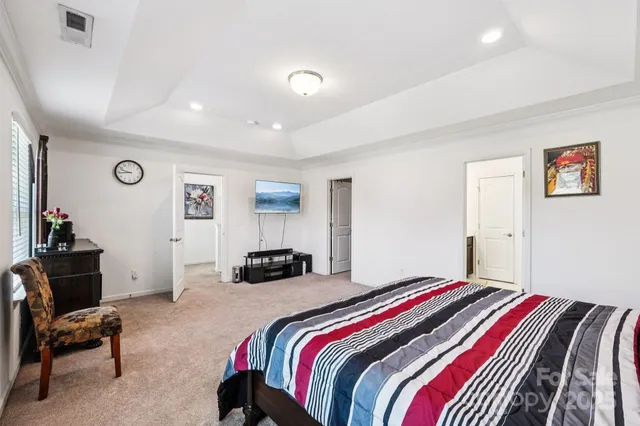 a bedroom with a bed and a chair