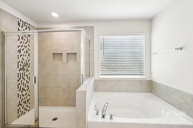 a white bath tub sitting next to a window