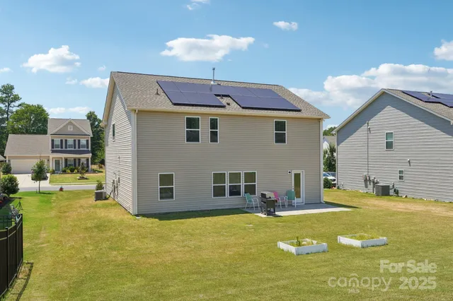 a view of a house with a backyard
