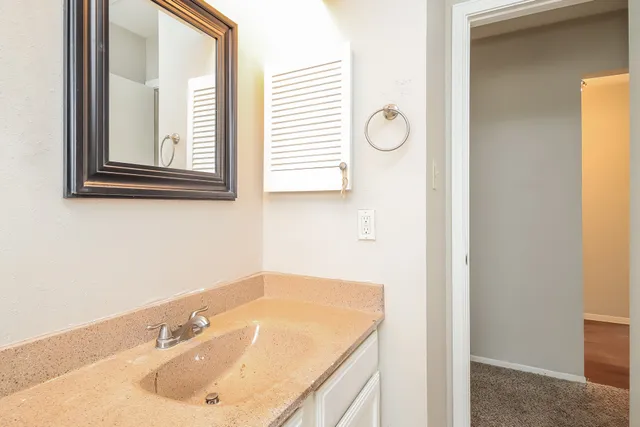 a bathroom with a sink and a window