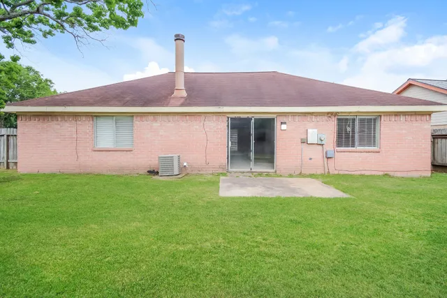 a front view of a house with a yard and plants