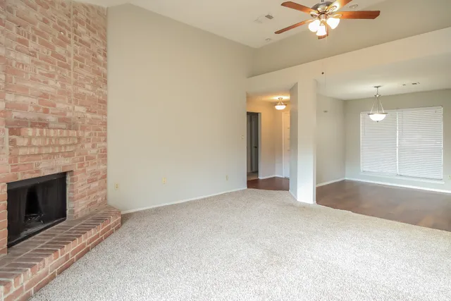 a view of an empty room with a fireplace