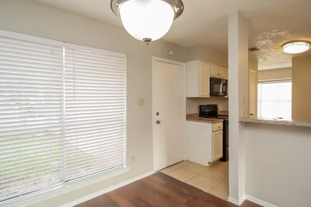 a view of a kitchen with wooden floor and a sink