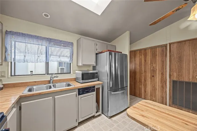 a kitchen with stainless steel appliances granite countertop a refrigerator and a sink