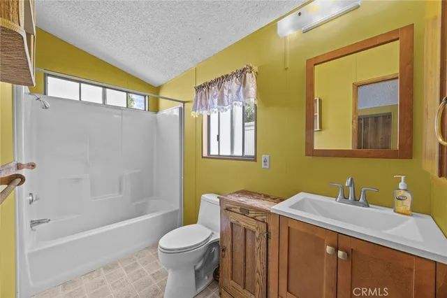 a bathroom with a granite countertop toilet sink and a bathtub