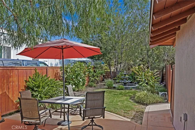 a view of a chair and table in the backyard