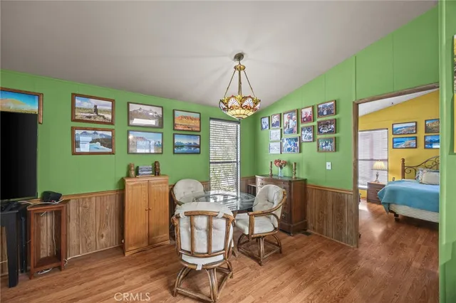 a living room with furniture a window and wooden floor