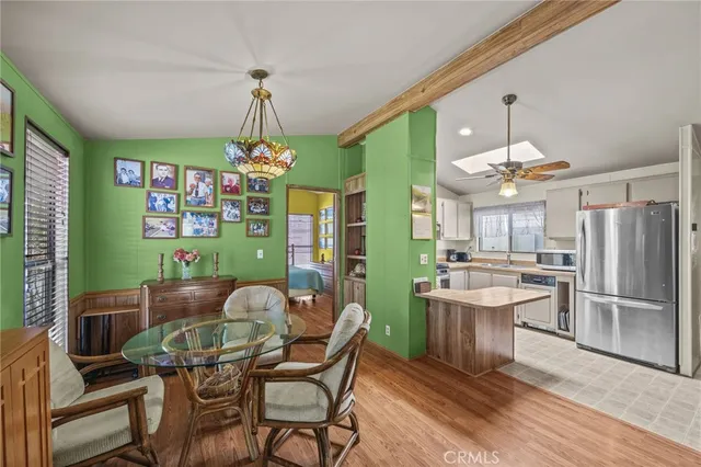 a dining room with furniture a chandelier and window