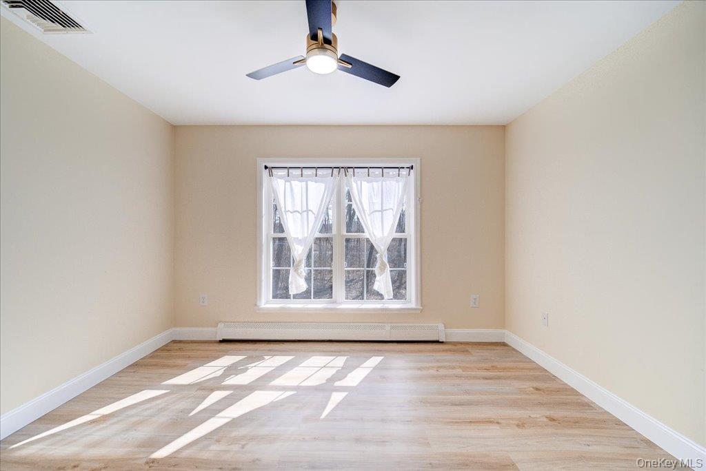 237 South Ohioville Road New Paltz, NY 12561 - Photo 23 of 48 an empty room with wooden floor chandelier and windows