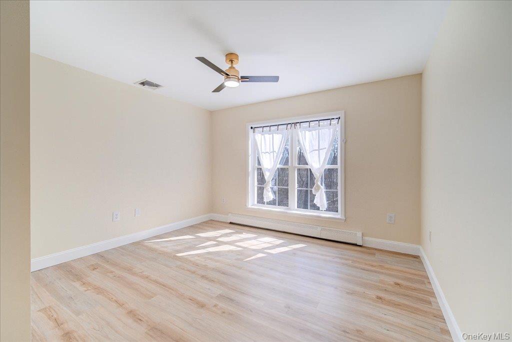 237 South Ohioville Road New Paltz, NY 12561 - Photo 24 of 48 an empty room with wooden floor fan and windows