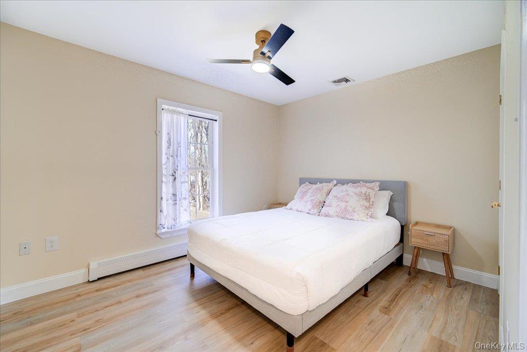237 South Ohioville Road New Paltz, NY 12561 - Photo 26 of 48 a bedroom with a bed and wooden floor