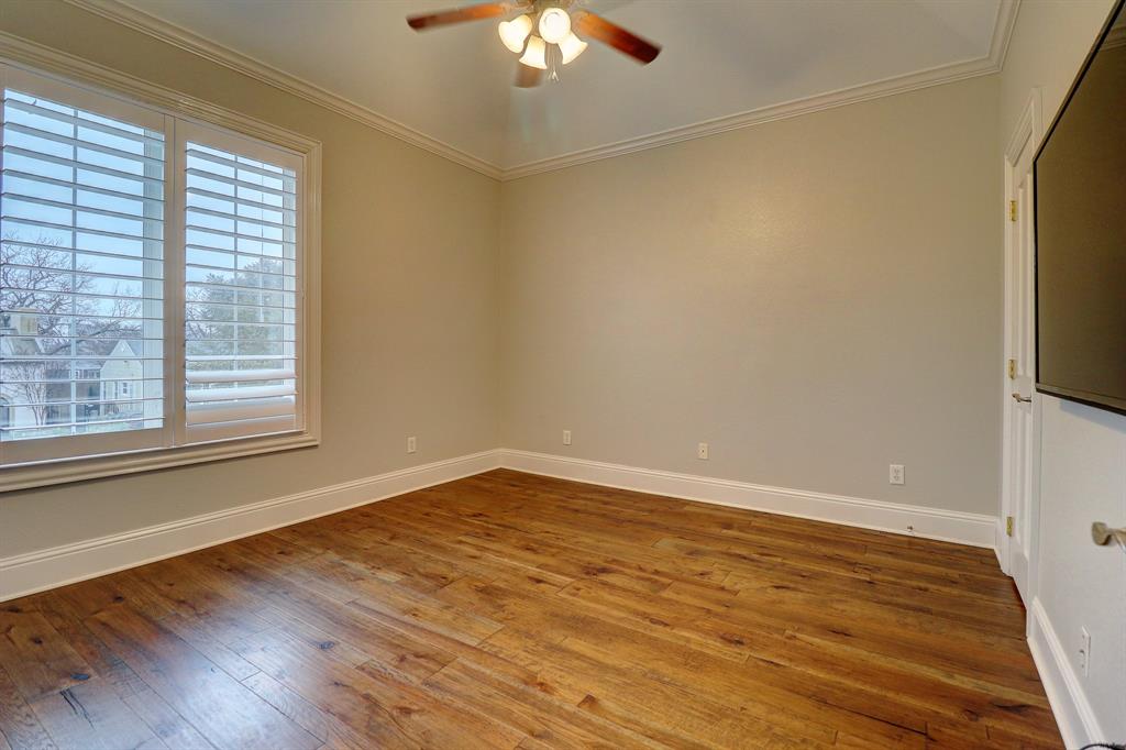 5606 Pershing Avenue Fort Worth, TX 76107 - Photo 8 of 12 a view of an empty room with wooden floor and a window