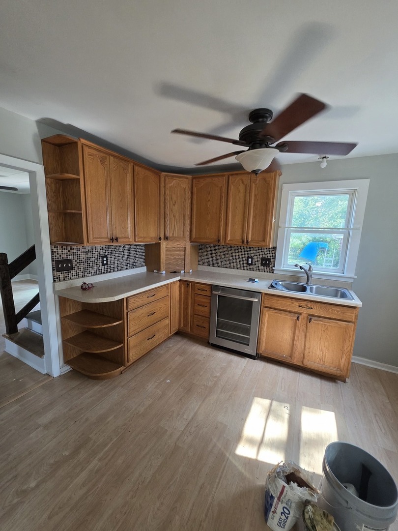 302 Dee Road North Aurora, IL 60542 - Photo 11 of 13 a kitchen with stainless steel appliances kitchen island granite countertop a sink and cabinets