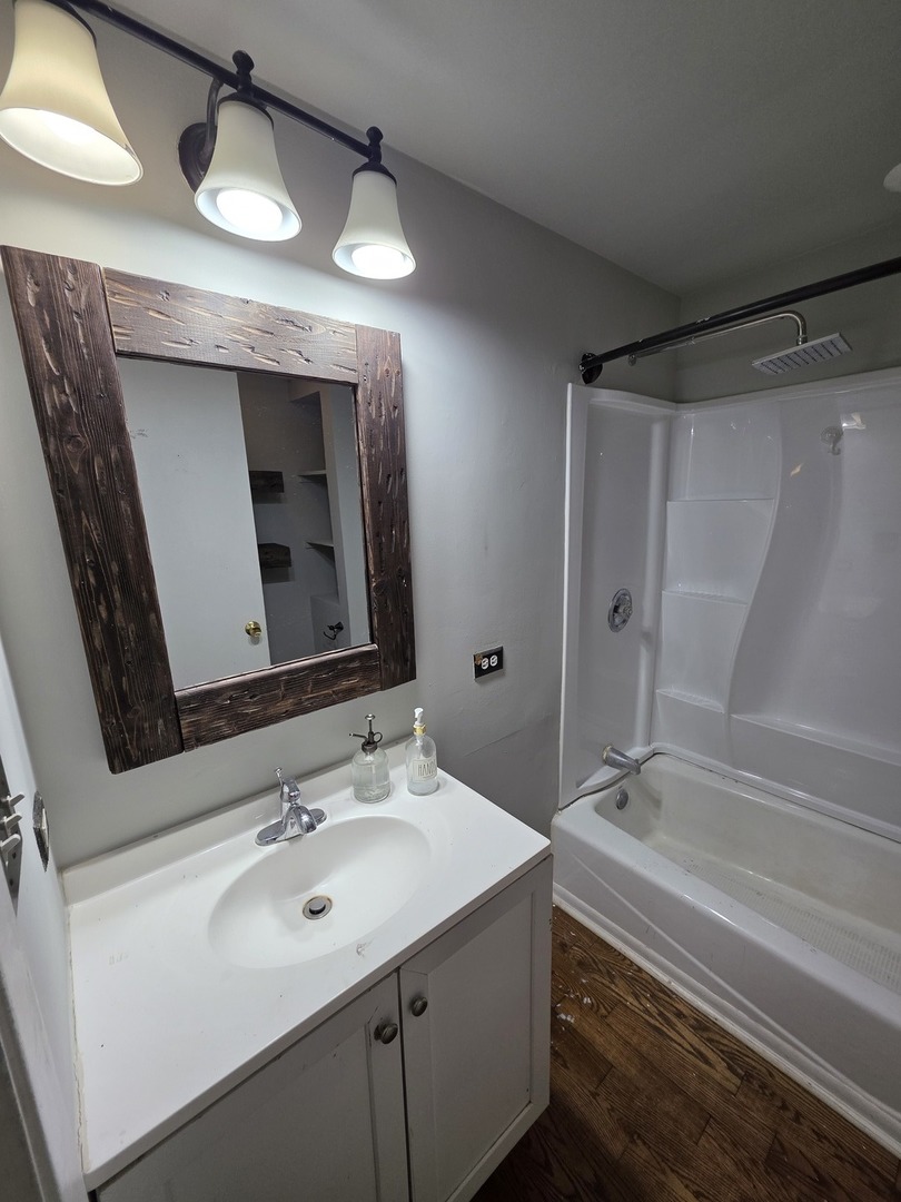 302 Dee Road North Aurora, IL 60542 - Photo 10 of 13 a bathroom with a sink and a mirror