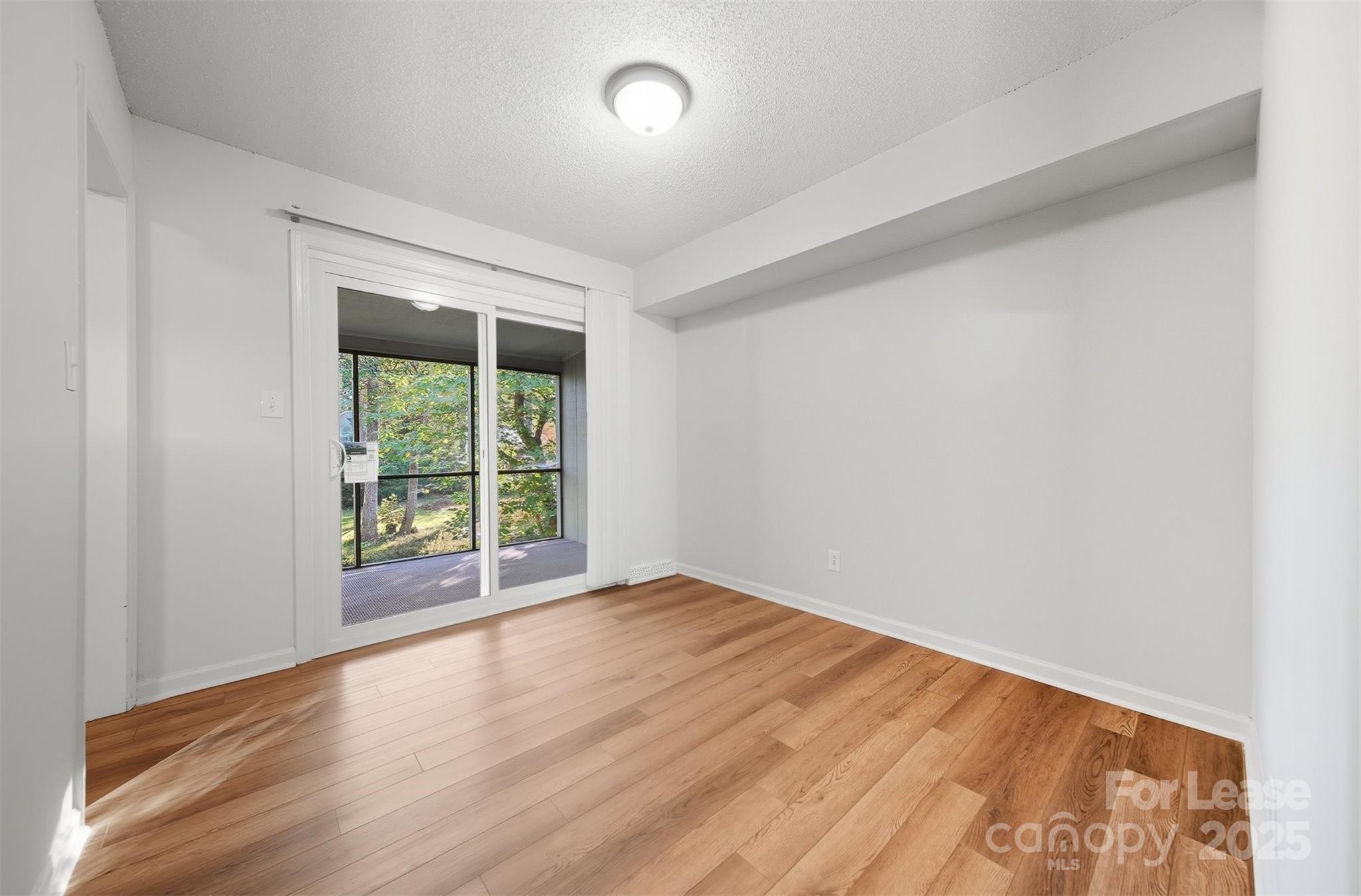 824 6th Street Northwest Hickory, NC 28601 - Photo 11 of 38 an empty room with wooden floor and windows