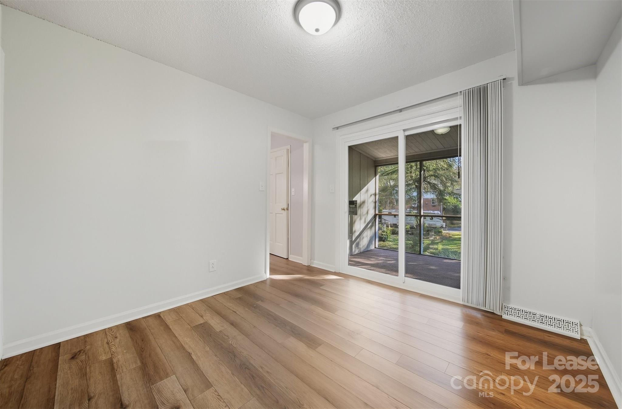 824 6th Street Northwest Hickory, NC 28601 - Photo 12 of 38 an empty room with wooden floor and windows