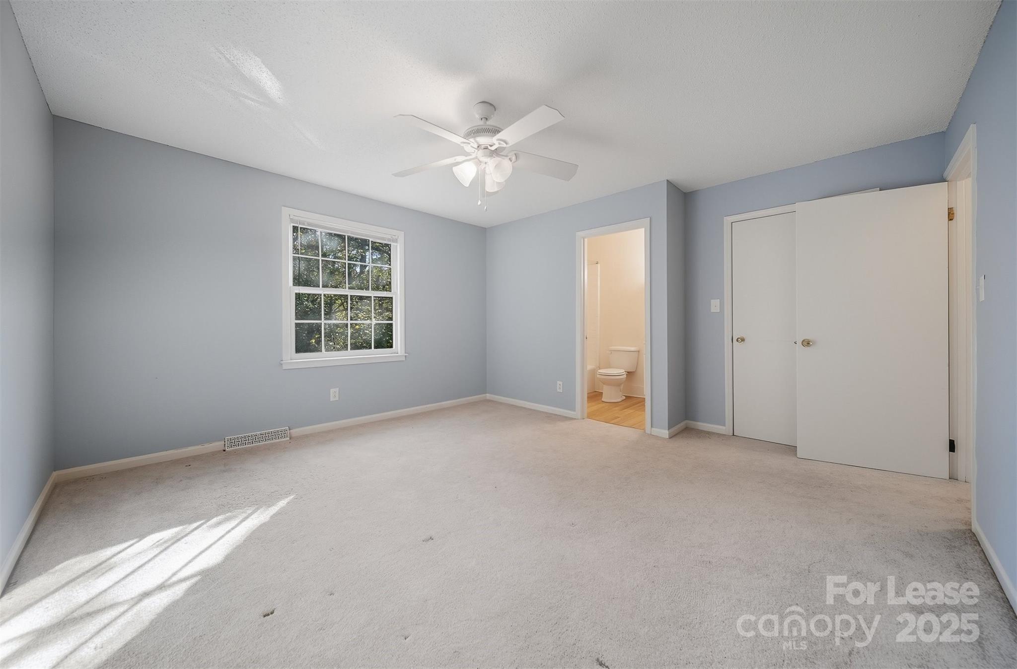 824 6th Street Northwest Hickory, NC 28601 - Photo 17 of 38 an empty room with windows and ceiling fan