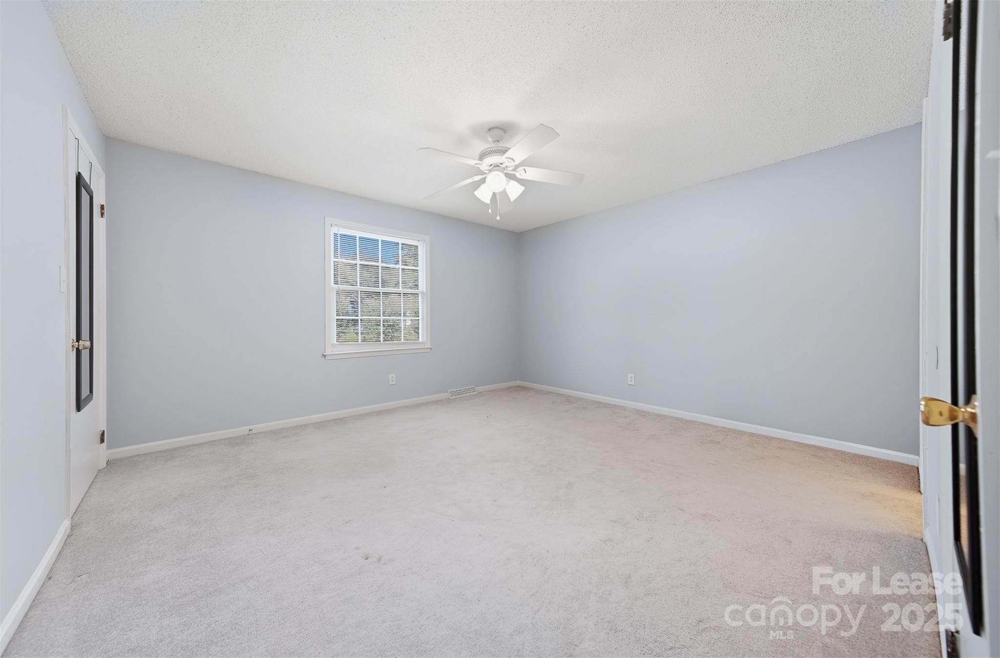 824 6th Street Northwest Hickory, NC 28601 - Photo 20 of 38 an empty room with windows and ceiling fan