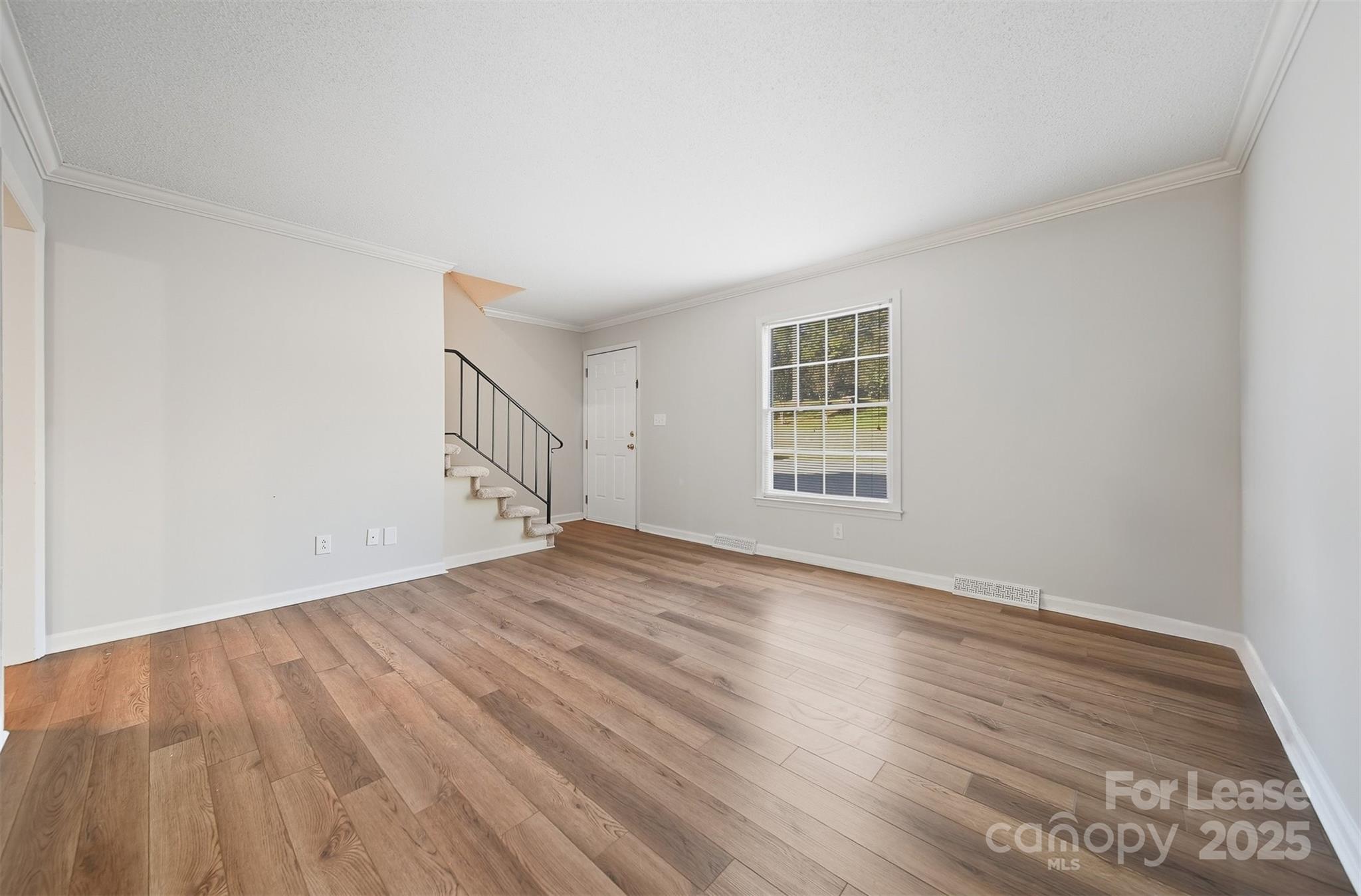 824 6th Street Northwest Hickory, NC 28601 - Photo 2 of 38 a view of empty room with wooden floor and fan