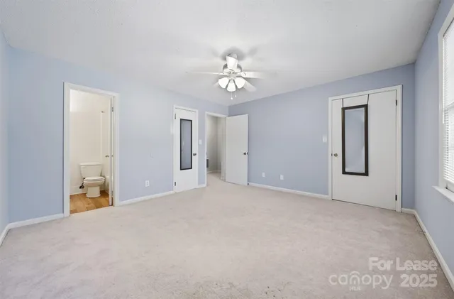 a view of a livingroom with a chandelier fan