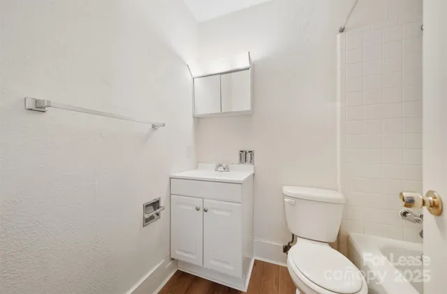 a white toilet sitting next to a bathroom sink