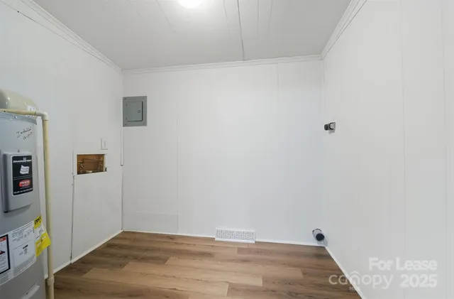 a view of a room with wooden floor