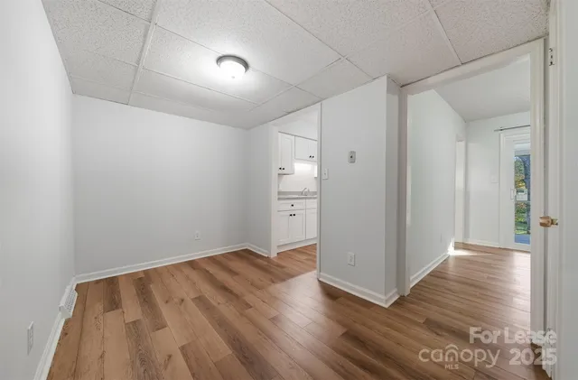 a view of an empty room with wooden floor