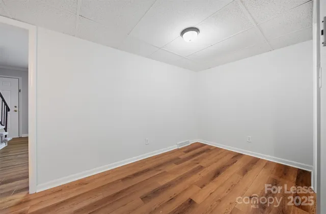a view of room with wooden floor and fan