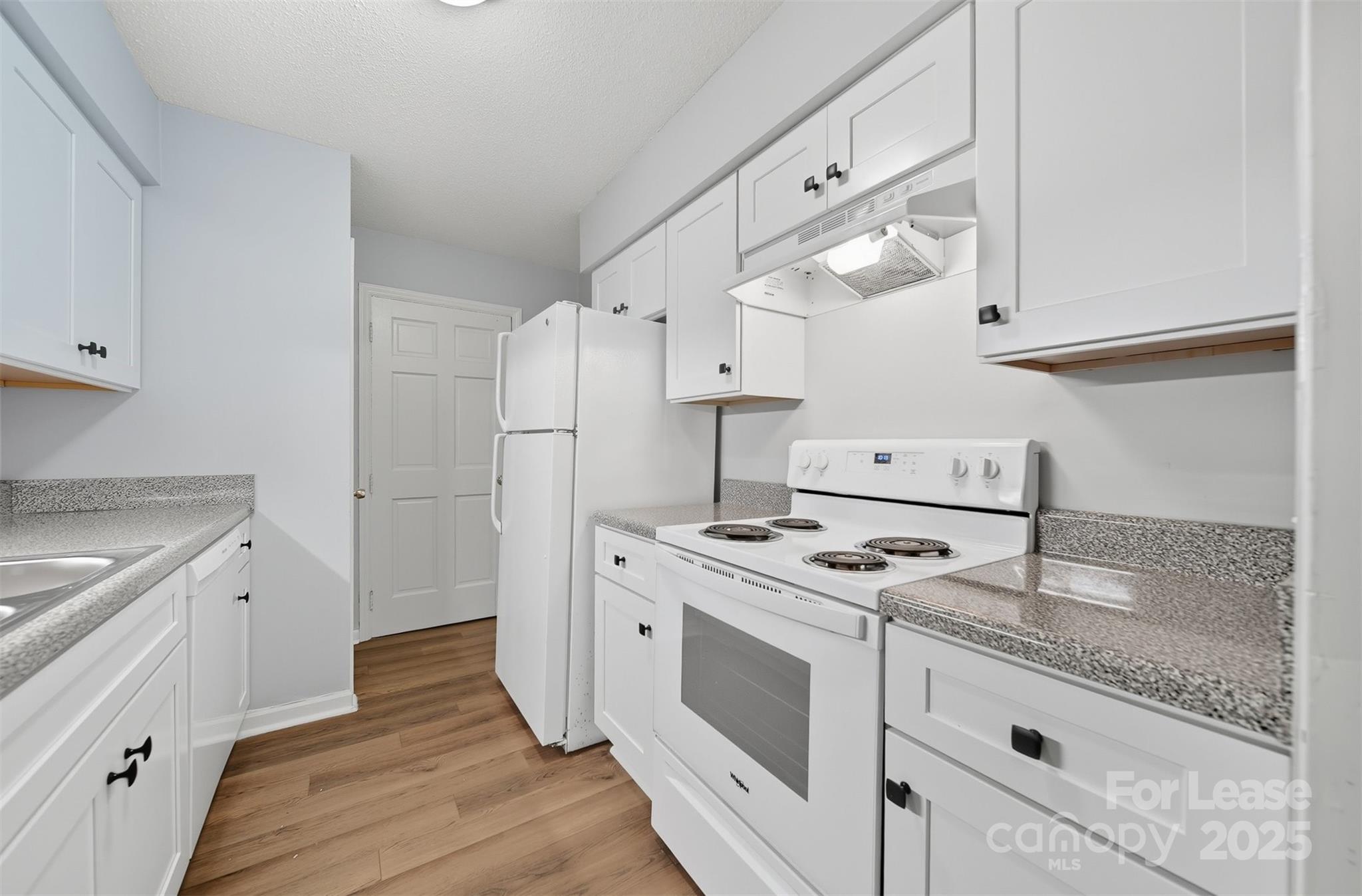 824 6th Street Northwest Hickory, NC 28601 - Photo 9 of 38 a kitchen with a stove cabinets and wooden floor