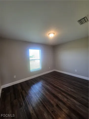a view of an empty room and wooden floor