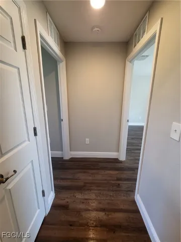 a view of room with wooden floor and staircase