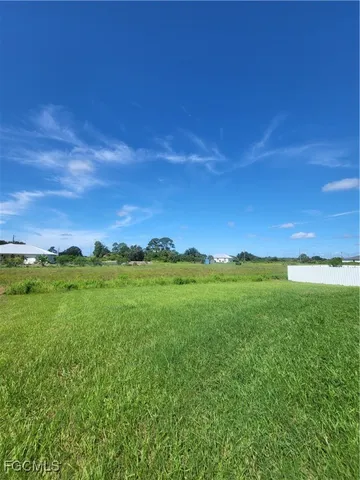 a view of a green field with an ocean