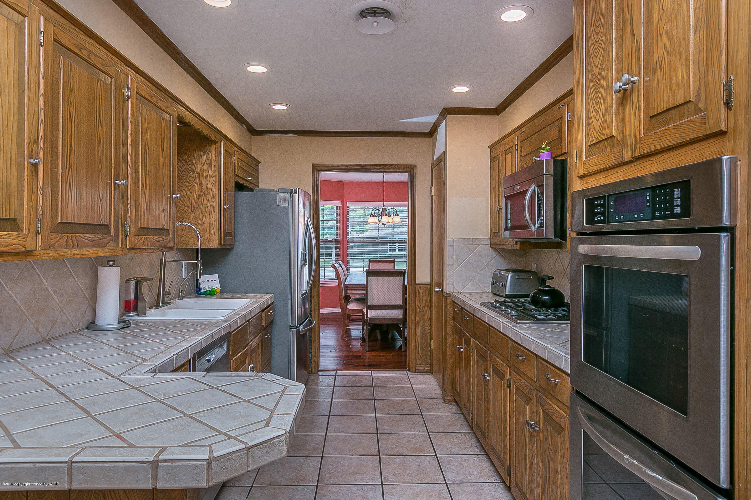 7109 Jameson Road Amarillo, TX 79106 - Photo 10 of 25 a kitchen with stainless steel appliances granite countertop a stove sink and cabinets