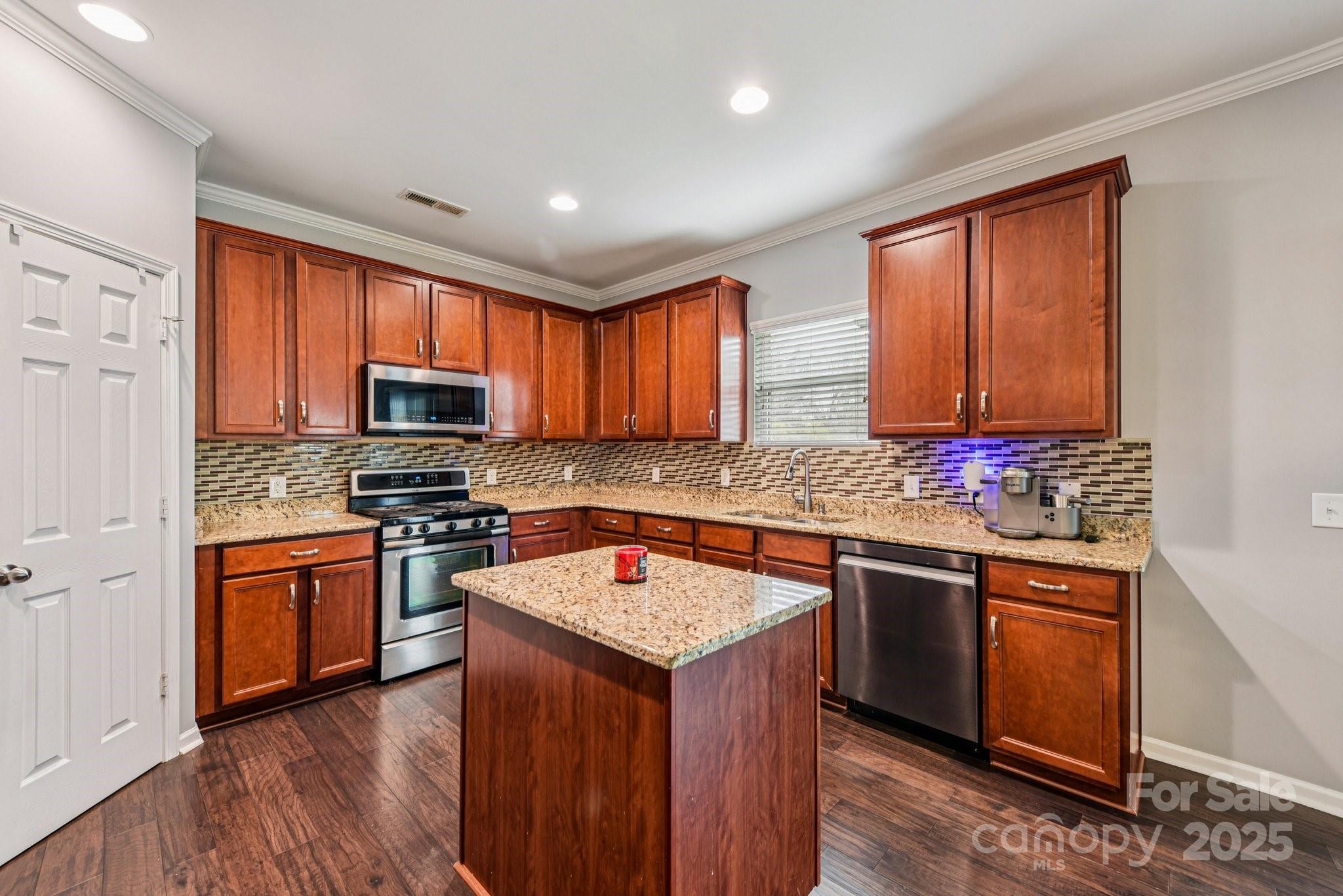 8826 Gray Willow Road Charlotte, NC 28227 - Photo 12 of 47 a kitchen with stainless steel appliances granite countertop refrigerator sink stove microwave and cabinets