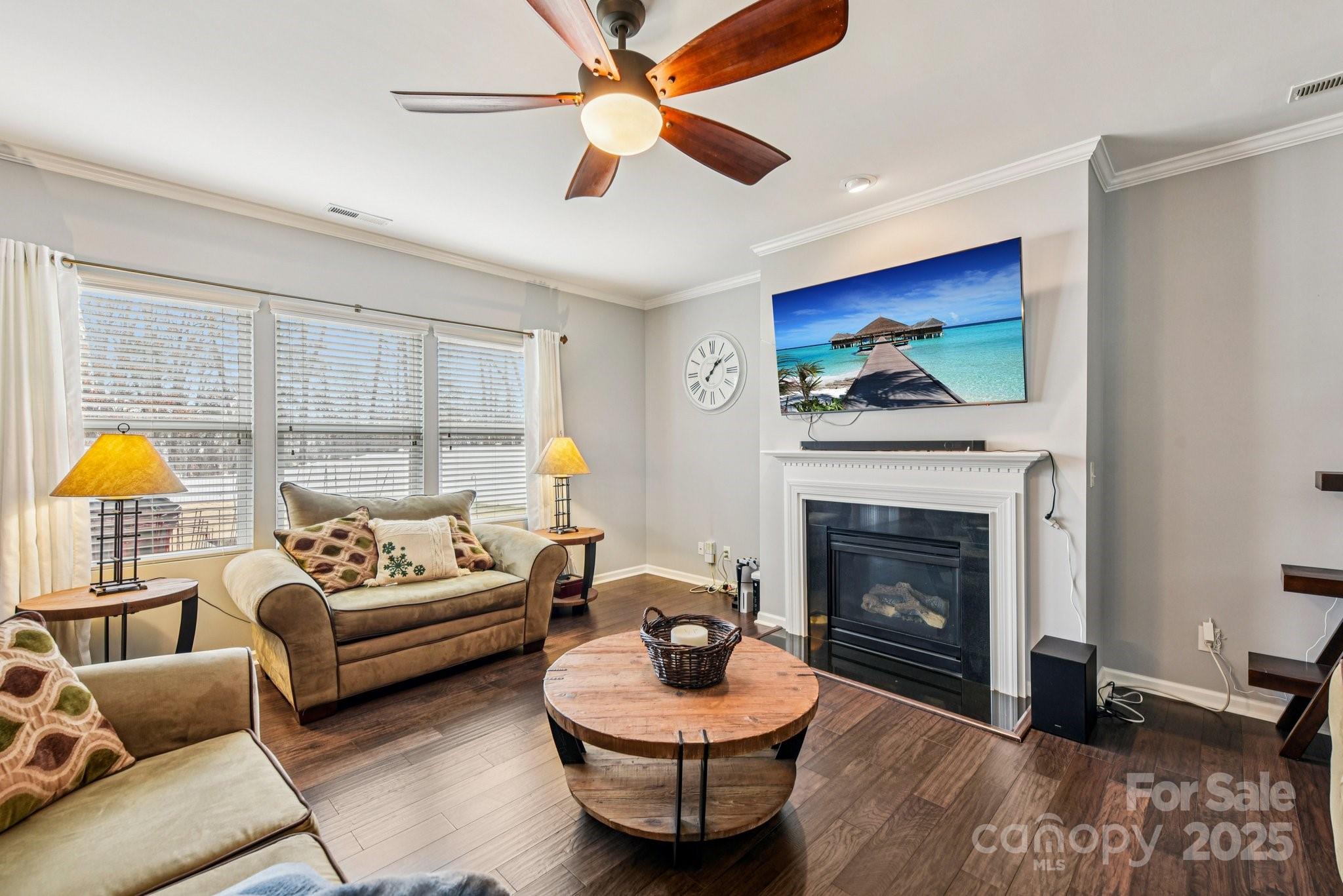 8826 Gray Willow Road Charlotte, NC 28227 - Photo 14 of 47 a living room with furniture a fireplace and a flat screen tv