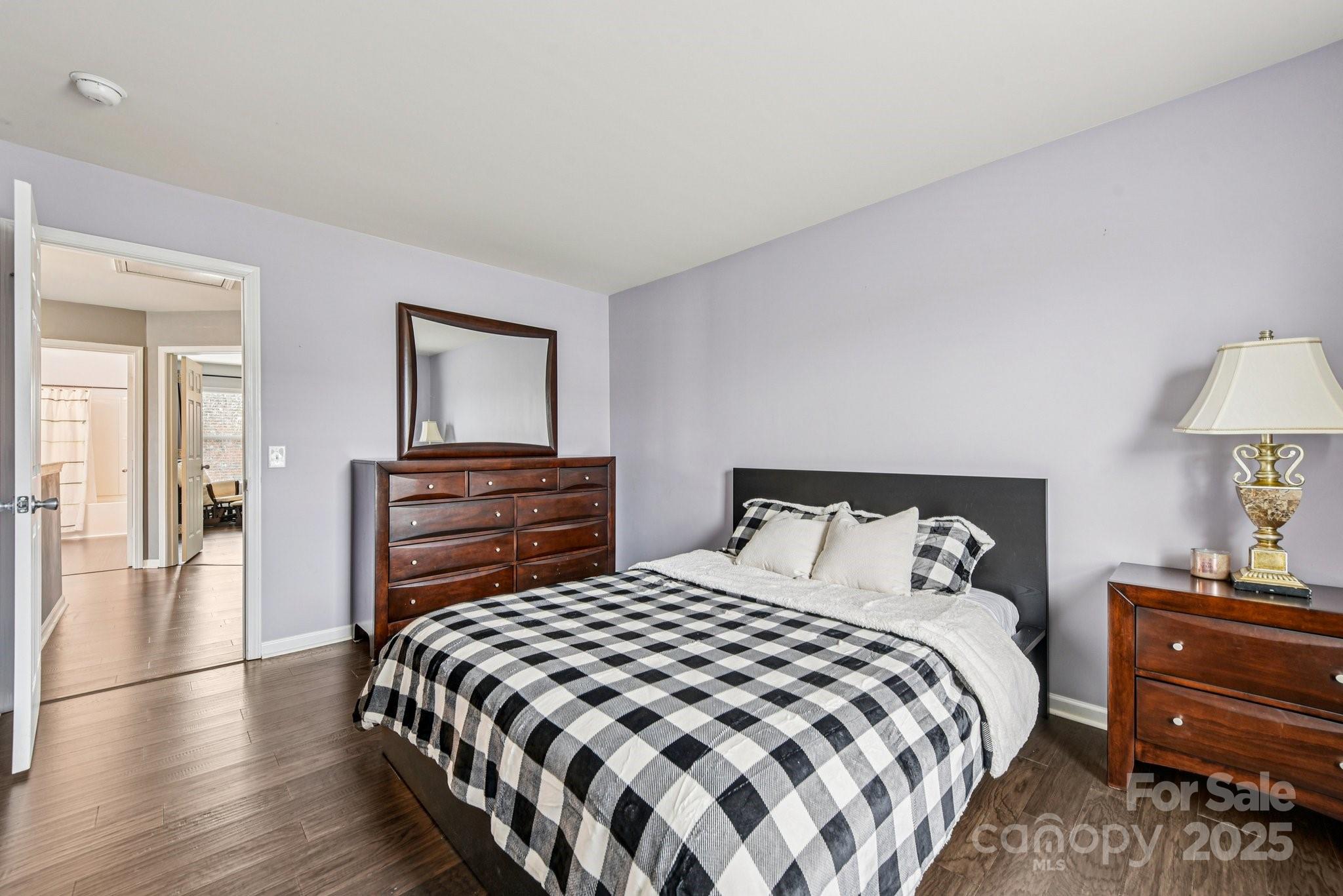 8826 Gray Willow Road Charlotte, NC 28227 - Photo 27 of 47 a bedroom with a bed and a lamp on table