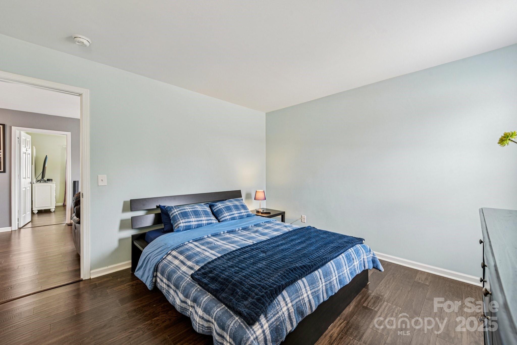 8826 Gray Willow Road Charlotte, NC 28227 - Photo 30 of 47 a bedroom with a bed and wooden floor