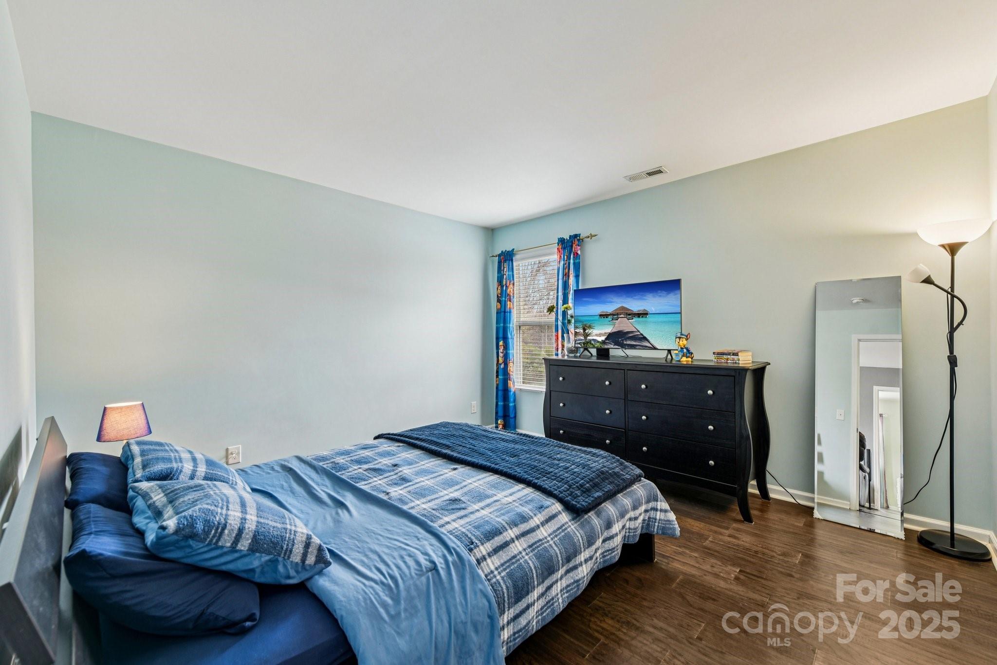 8826 Gray Willow Road Charlotte, NC 28227 - Photo 31 of 47 a bedroom with a bed and a mirror on dresser
