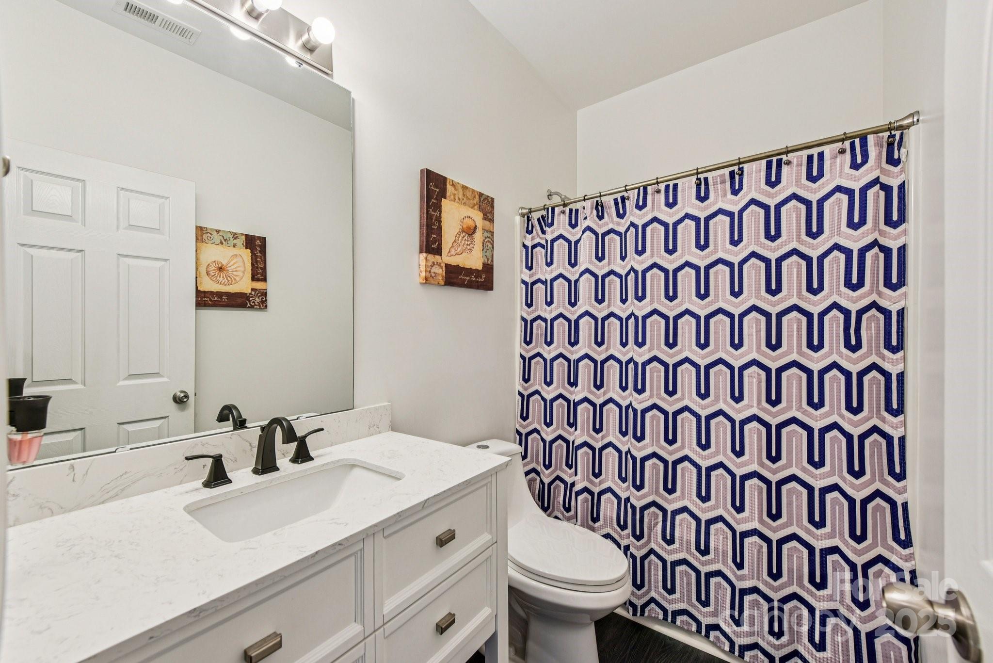 8826 Gray Willow Road Charlotte, NC 28227 - Photo 7 of 47 a bathroom with a sink and a mirror