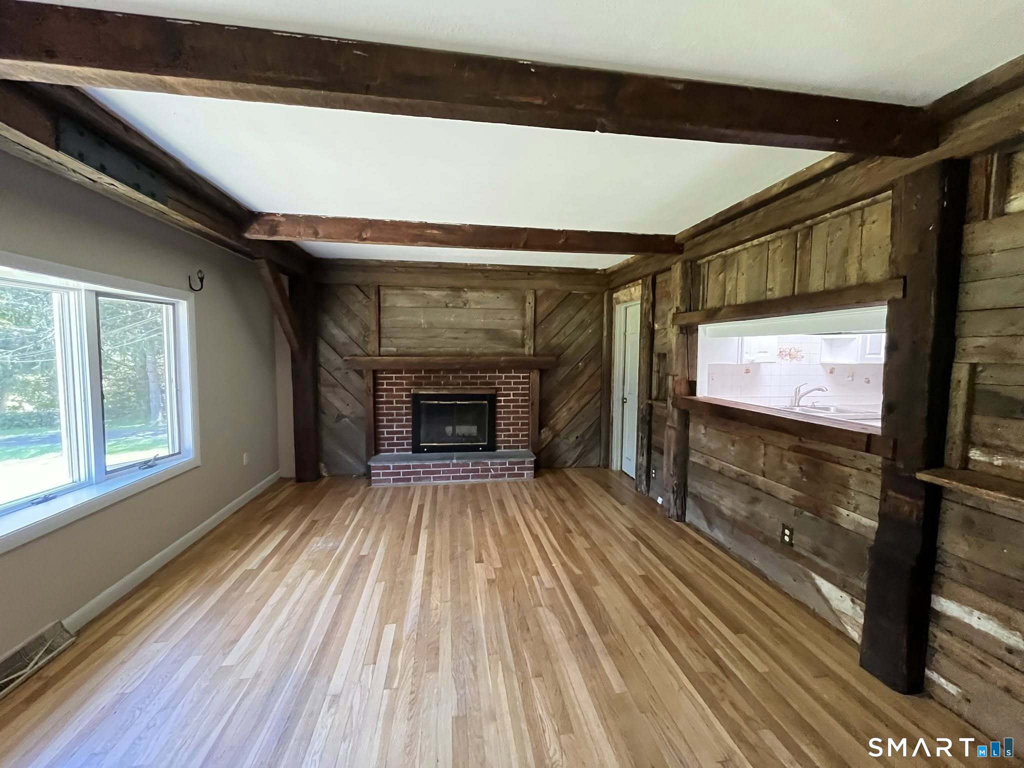 62 Old Hawleyville Road Bethel, CT 06801 - Photo 23 of 46 a view of empty room with wooden floor and fireplace