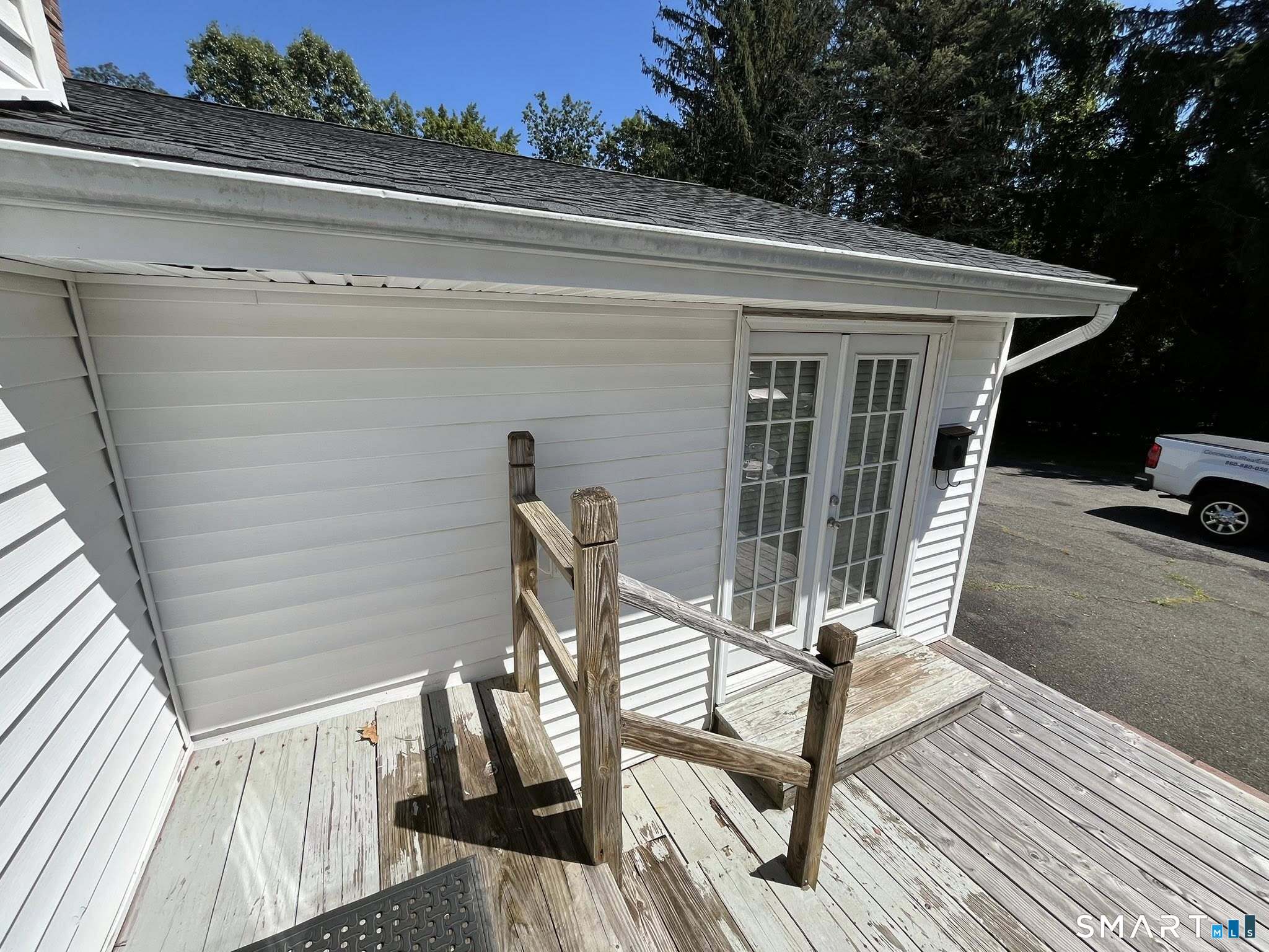 62 Old Hawleyville Road Bethel, CT 06801 - Photo 33 of 46 a view of a patio with table and chairs with wooden floor and fence