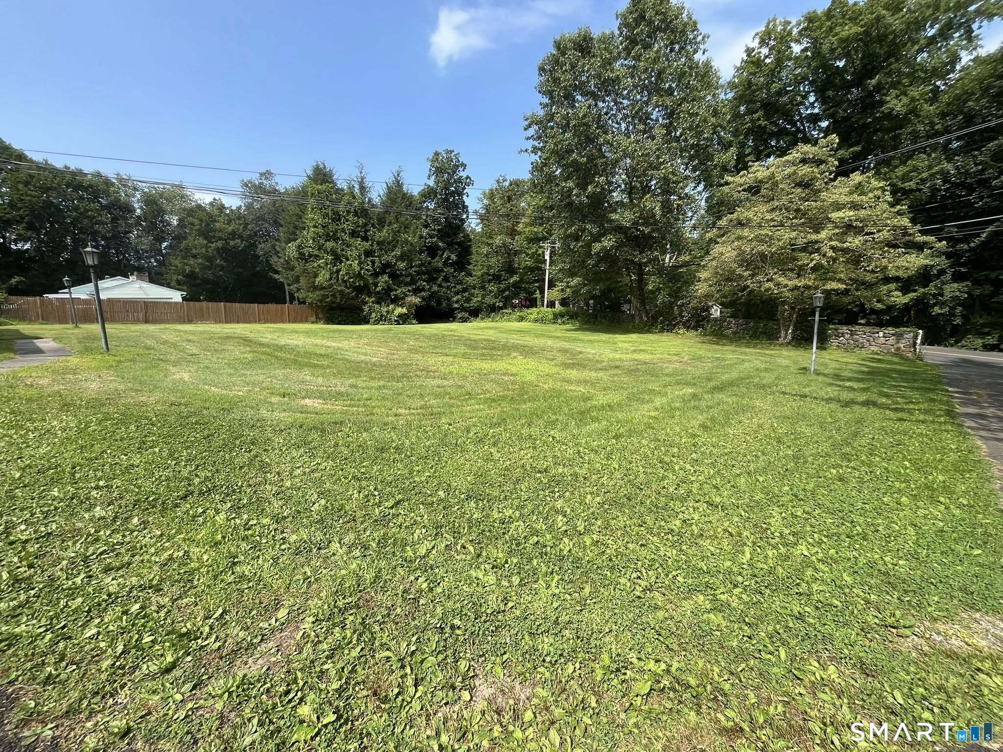 62 Old Hawleyville Road Bethel, CT 06801 - Photo 42 of 46 a view of a green field with wooden fence