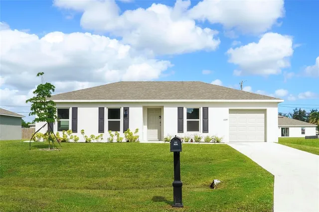 a front view of house with a garden and patio