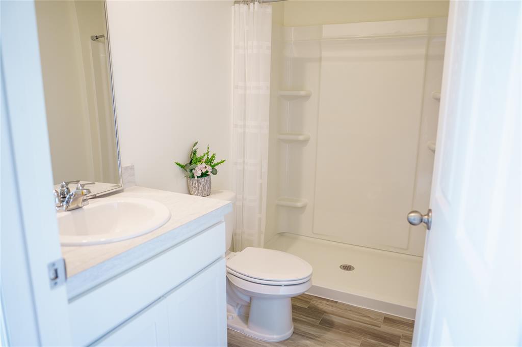 1229 Southwest San Antonio Avenue Port St. Lucie, FL 34953 - Photo 17 of 31 a bathroom with a sink a toilet and shower