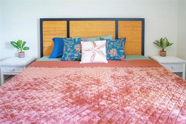 a bedroom with a large bed and a window