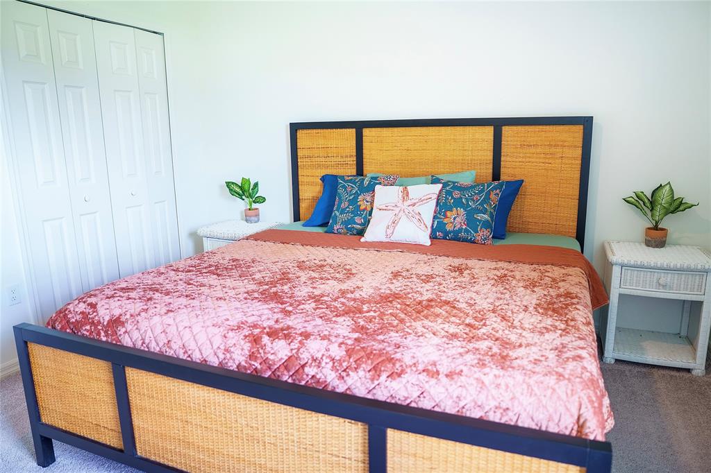 1229 Southwest San Antonio Avenue Port St. Lucie, FL 34953 - Photo 20 of 31 a large bed sitting in a bedroom next to a window