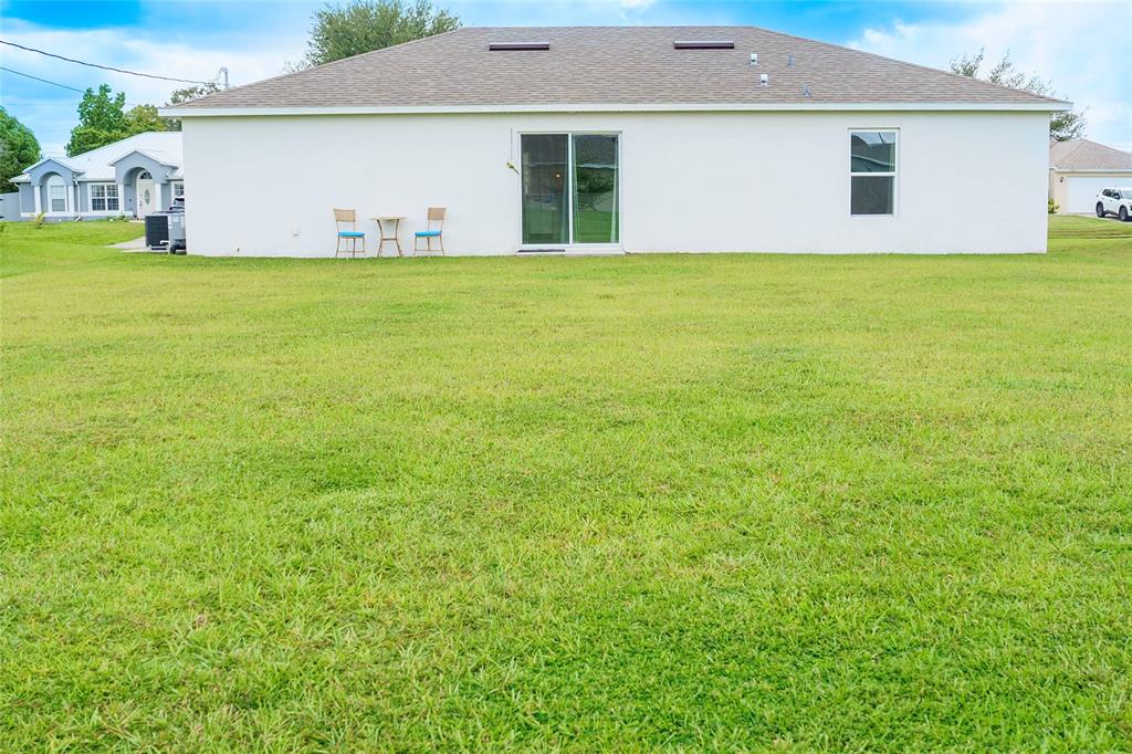 1229 Southwest San Antonio Avenue Port St. Lucie, FL 34953 - Photo 2 of 31 a front view of house with an outdoor space and seating