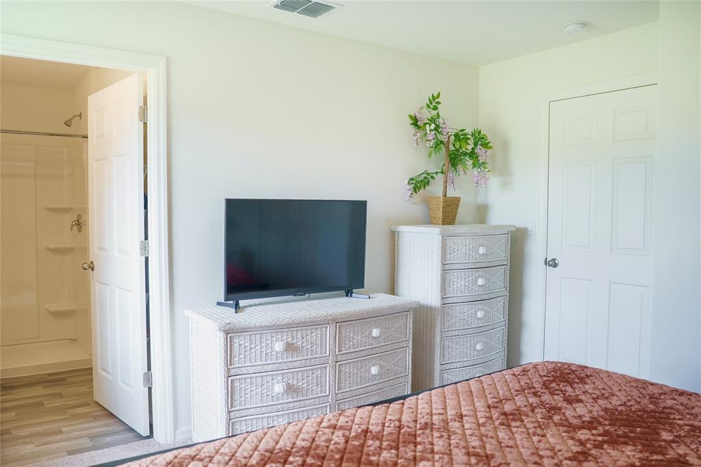 1229 Southwest San Antonio Avenue Port St. Lucie, FL 34953 - Photo 21 of 31 a bedroom with a bed and a dresser