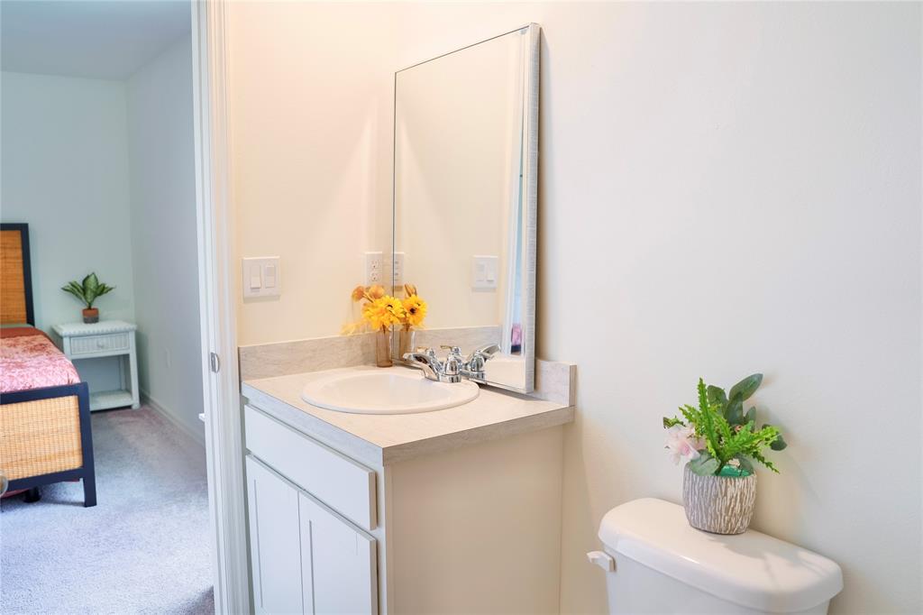 1229 Southwest San Antonio Avenue Port St. Lucie, FL 34953 - Photo 22 of 31 a bathroom with a sink a toilet and a mirror