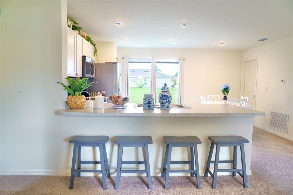 1229 Southwest San Antonio Avenue Port St. Lucie, FL 34953 - Photo 8 of 31 a kitchen with a table and chairs in it